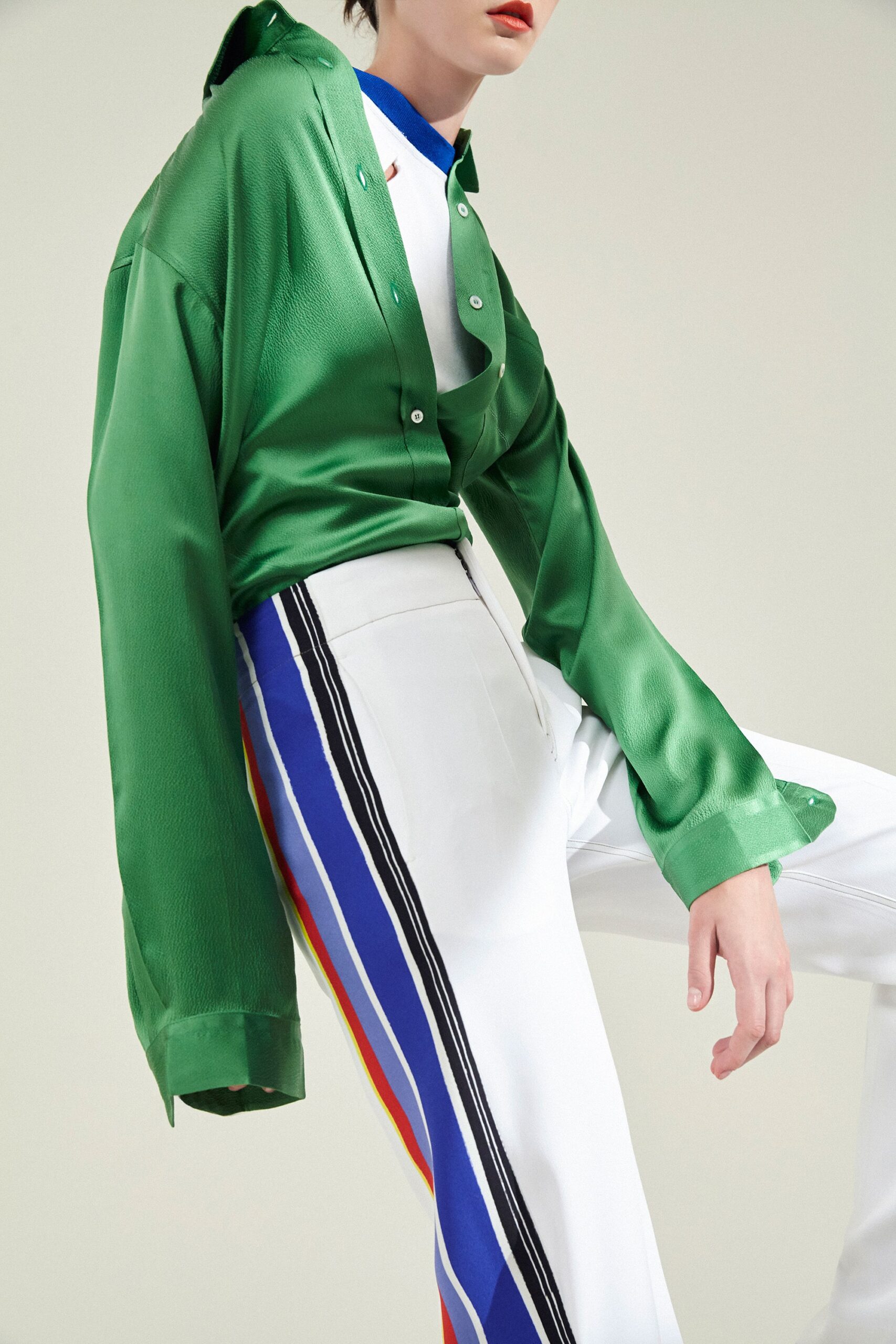 green silk shirt with tailored pants