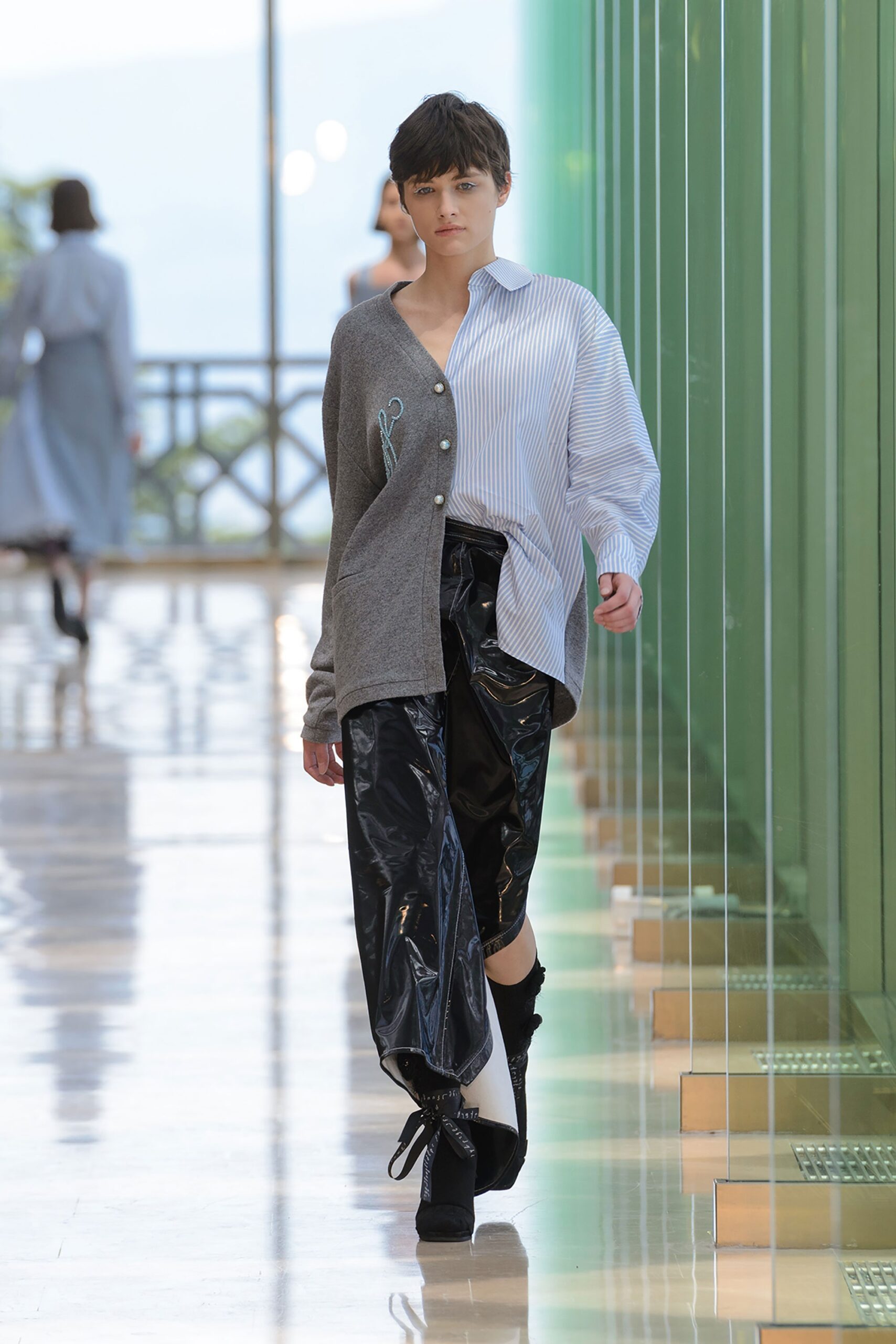 gray and white relaxed shirt with black vinyl pants