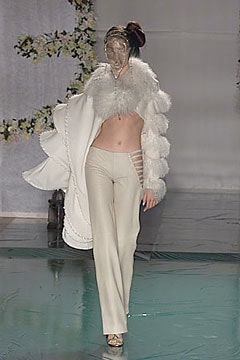 white fur coat and beige pants