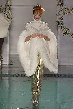 white faux-fur coat with gold pants