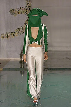 green fitted top with cutout and white pants