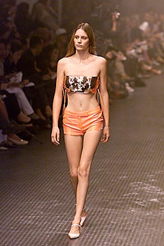 silver metallic crop-top with orange shorts