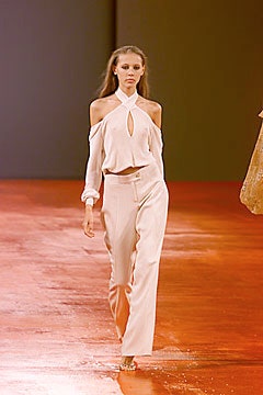 white silk off-shoulder blouse and beige tailored pants
