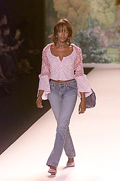 pink ruffled blouse with flared jeans