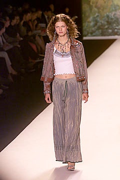 brown leather jacket with white top and gray pants