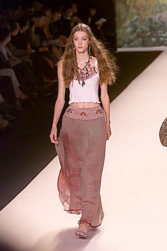 white embroidered sleeveless top and red tiered skirt