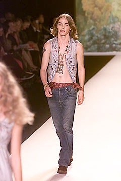 gray embroidered vest with blue jeans