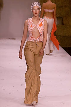 fitted white top with embroidered details and flared beige pants