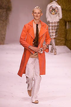 orange coat beige top white pants