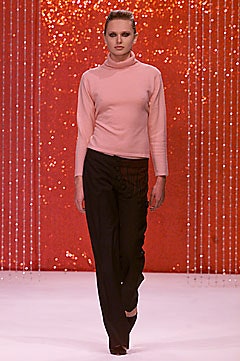 pink fitted turtleneck top and black relaxed pants