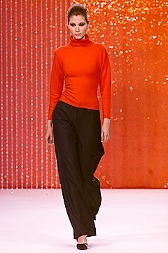 red fitted turtleneck top and black relaxed pants
