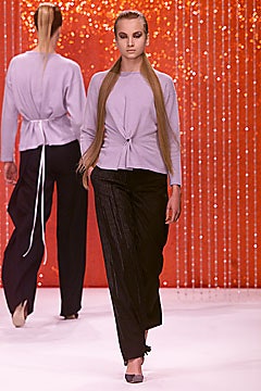 lavender fitted top and black pleated pants
