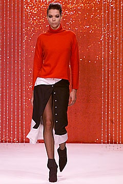 red fitted turtleneck and black skirt