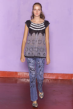 black and white embroidered top with flared jeans