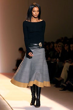 black fitted top with gray pleated skirt