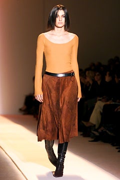 orange fitted top with brown skirt