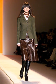 green tailored blazer with brown pleated skirt