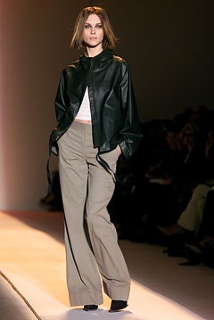 black leather oversized jacket with beige relaxed pants