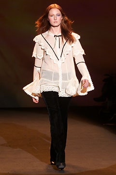 white ruffled blouse with black pants