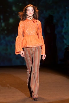 orange embroidered top with flared pants
