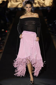 black mesh off-shoulder top and pink fringed skirt