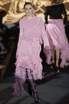 pink fringed suede coat and black vinyl pants