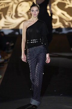 black fitted asymmetric top and blue slim pants