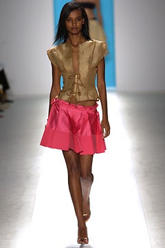 gold silk sleeveless top and pink pleated skirt