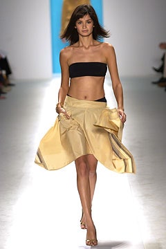 black strapless top and gold skirt
