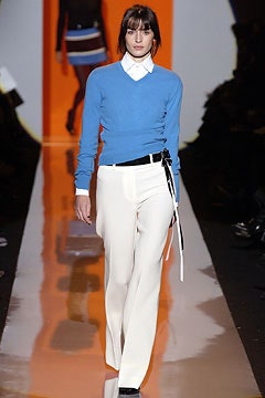 blue fitted sweater and white tailored pants