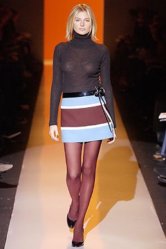 black sheer turtleneck top with color-blocked skirt