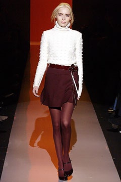 fitted white turtleneck top with red skirt