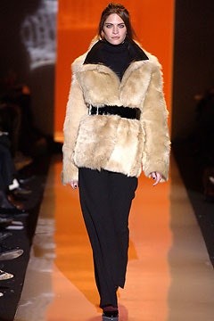 beige fur coat with black pants