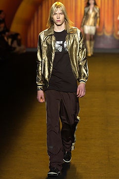 gold metallic fitted jacket with black t-shirt and brown pants