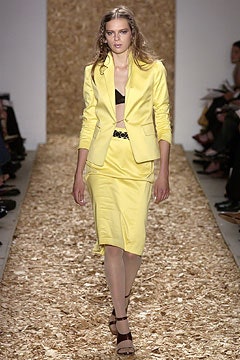 yellow fitted suit with black bra