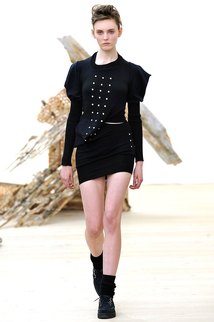 black fitted top and mini skirt