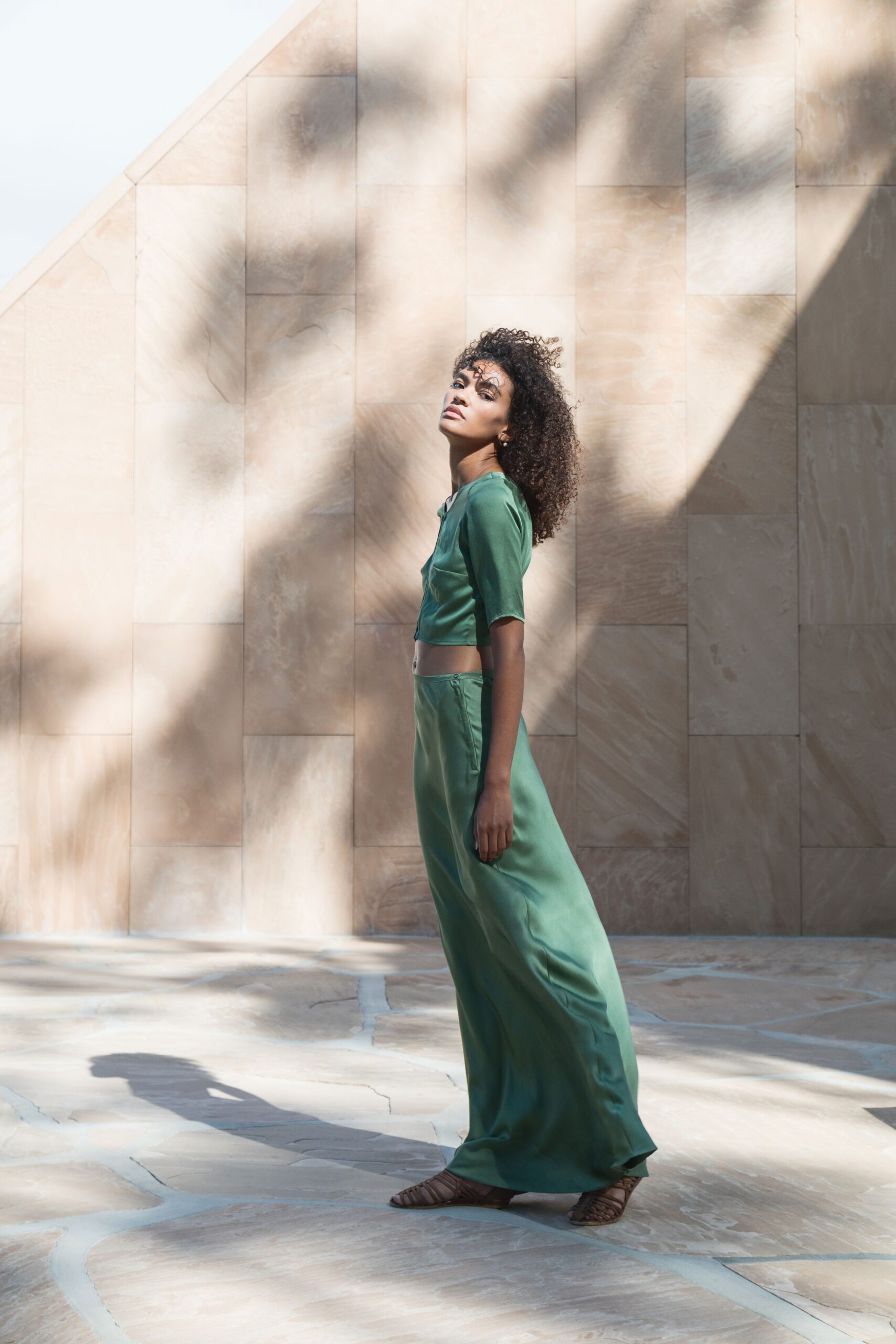 green silk cropped top and wide-leg pants