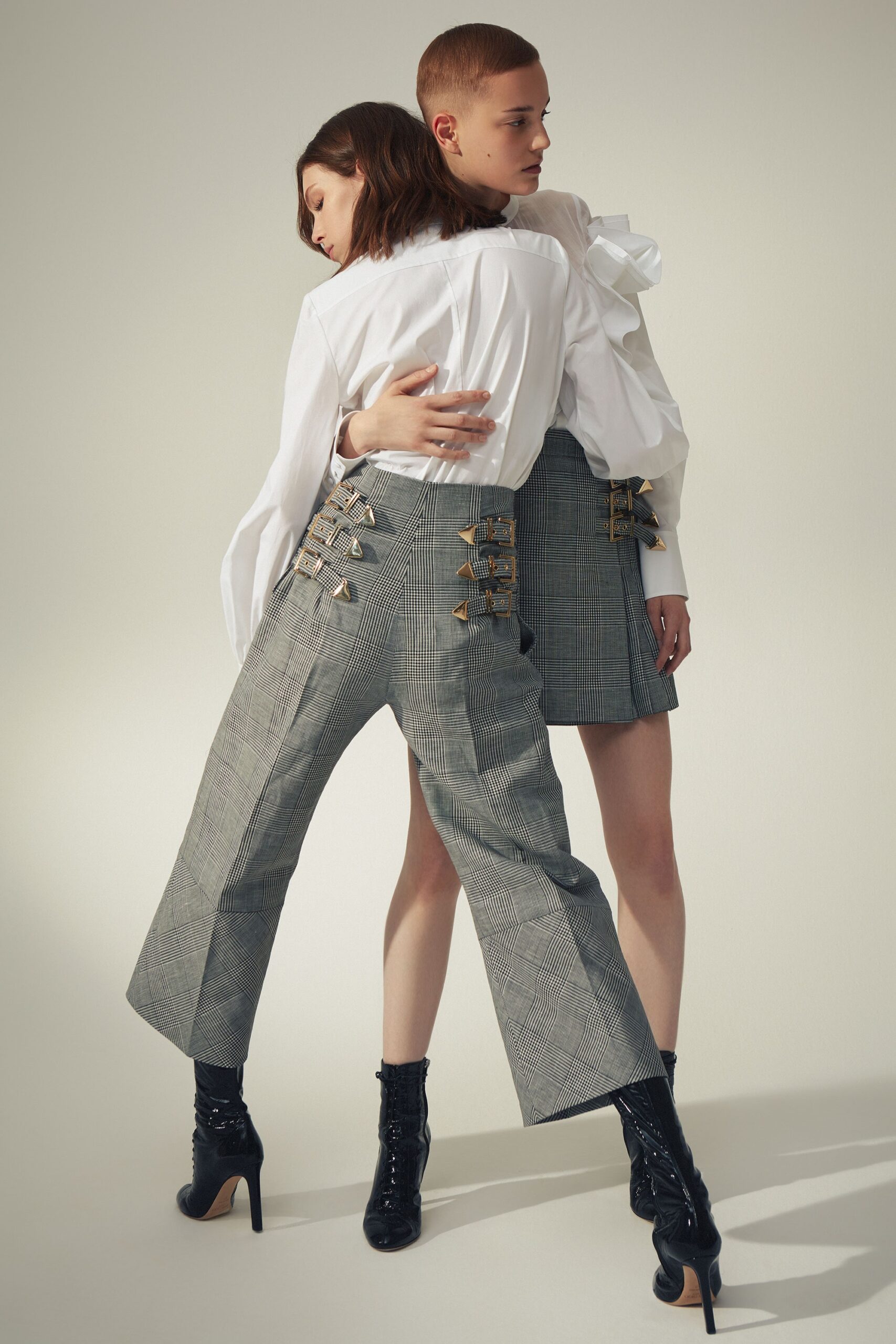 white ruffled shirt and gray pants