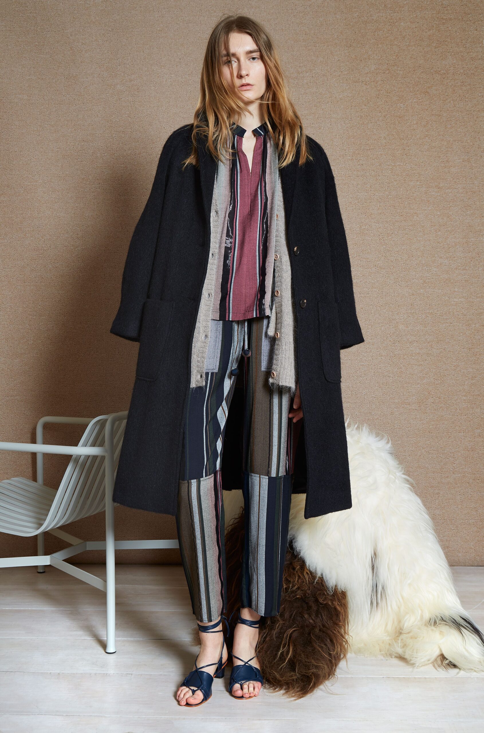 black wool coat with striped shirt and pants