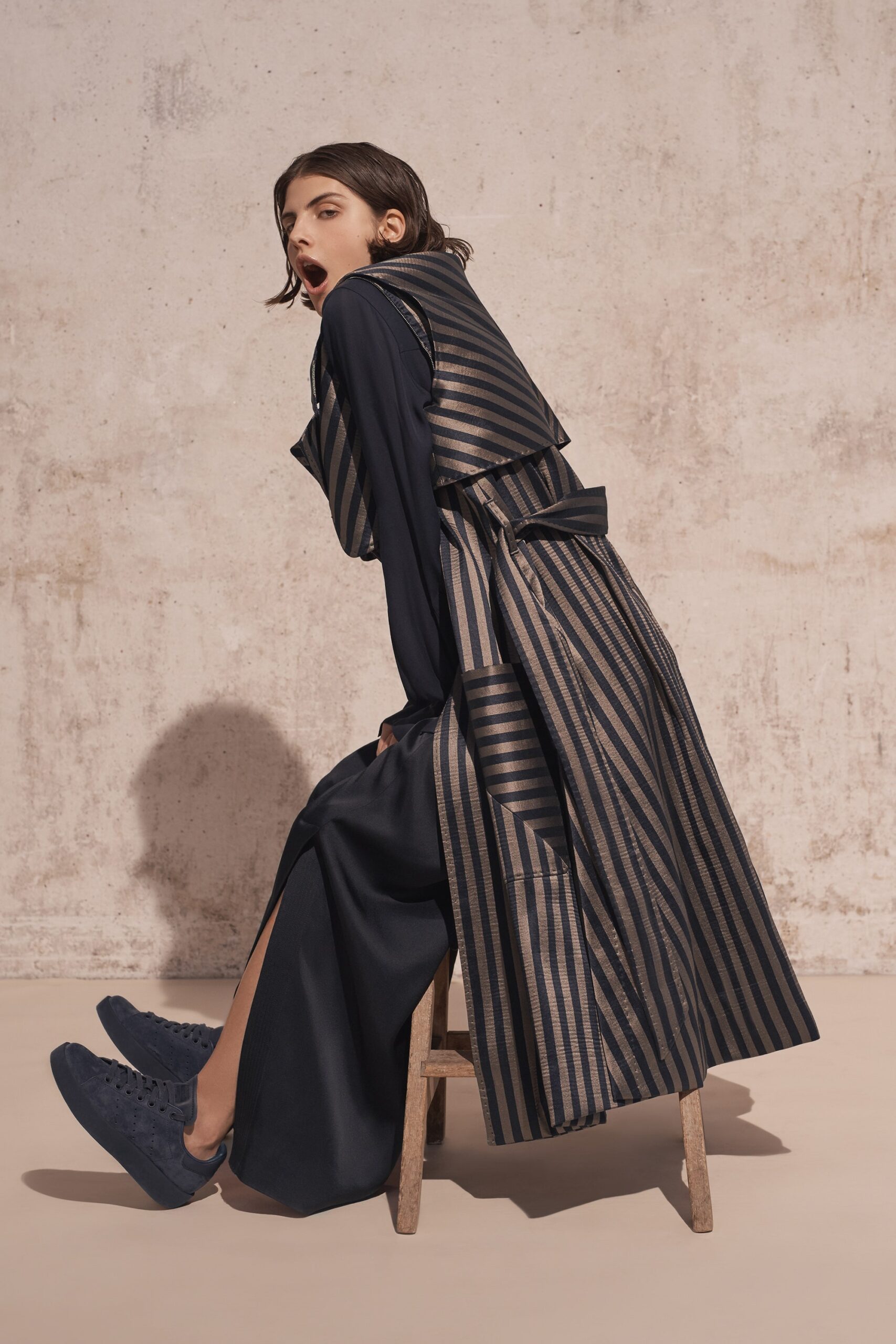 black fitted midi dress with layered coat