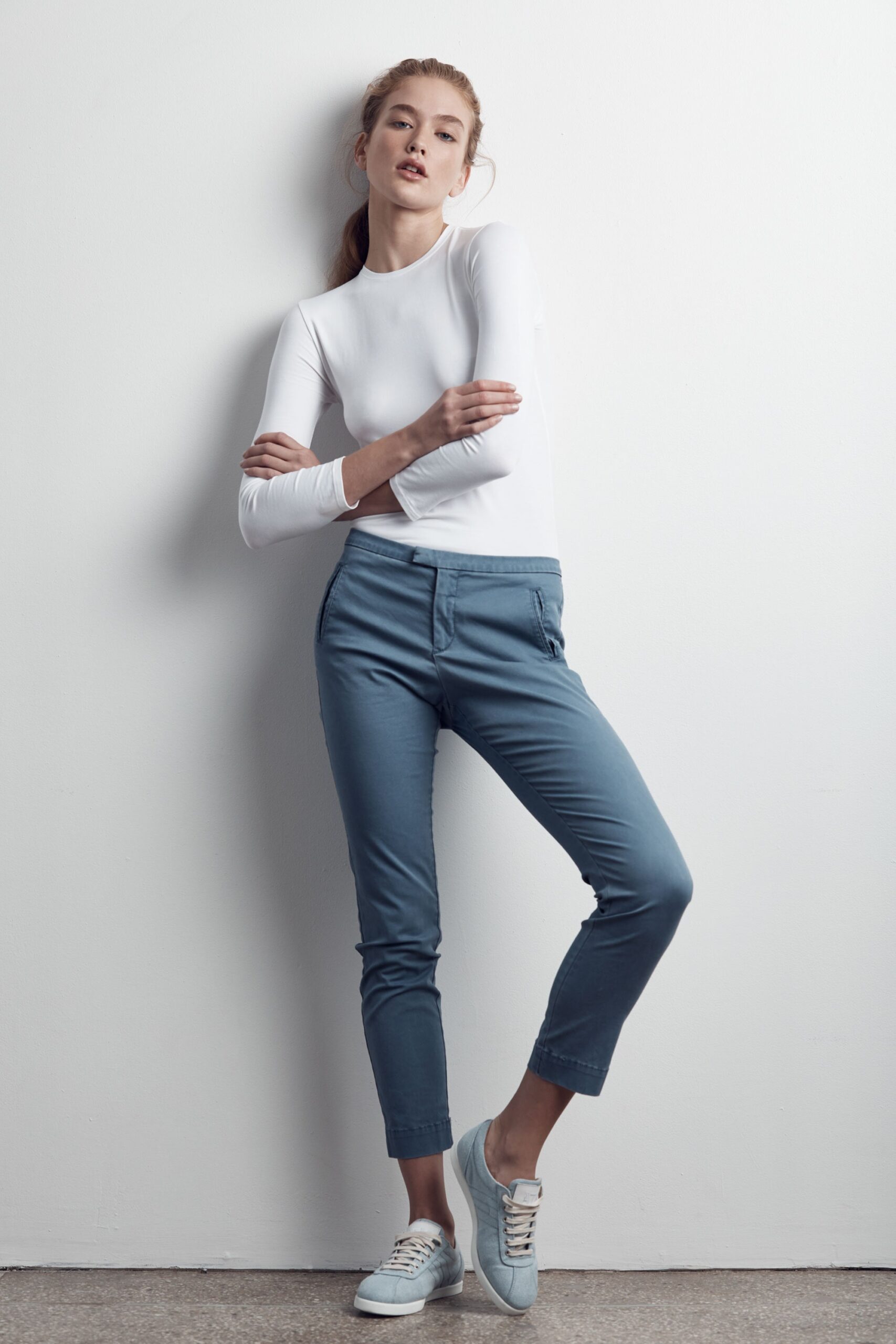 white fitted top with blue pants