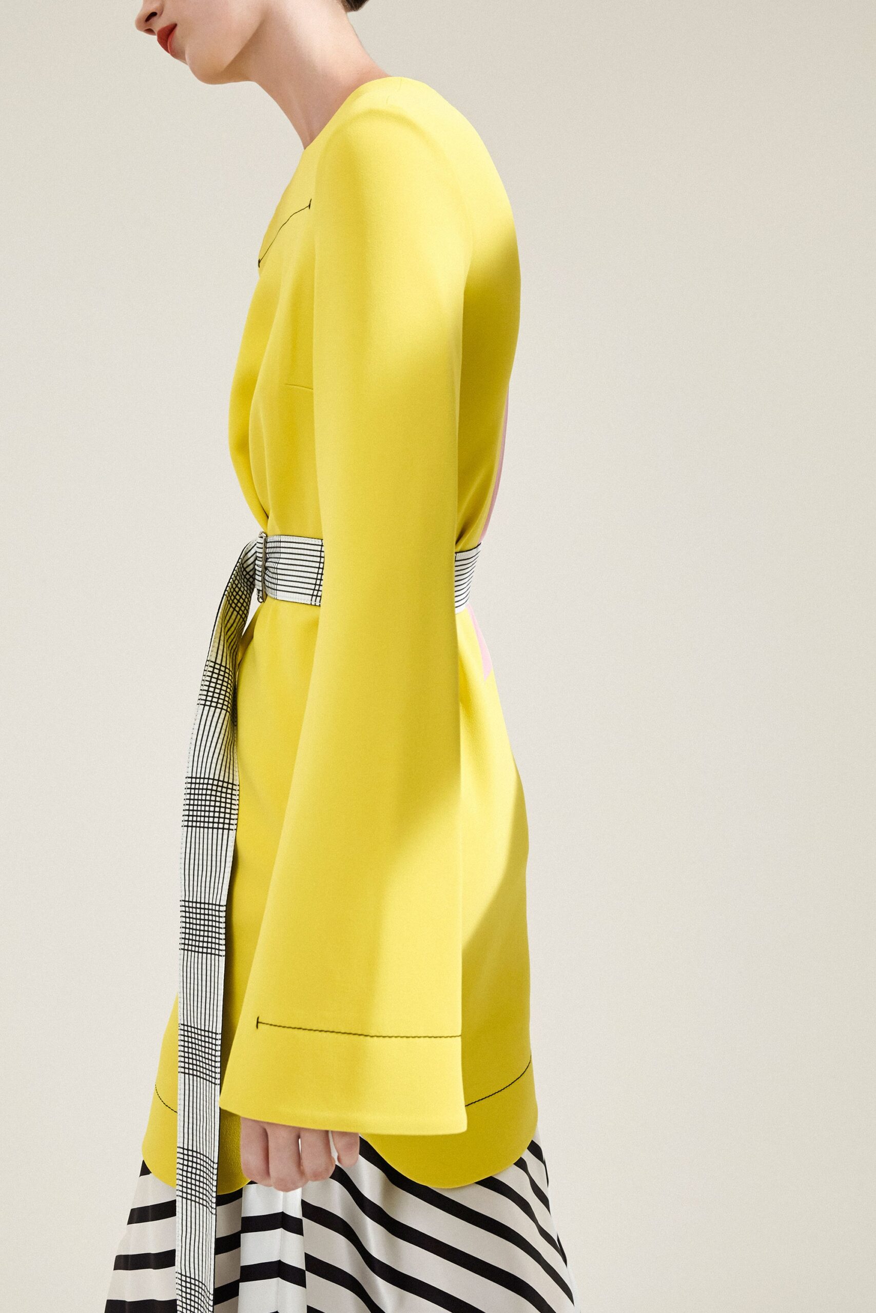 yellow fitted blazer with striped skirt