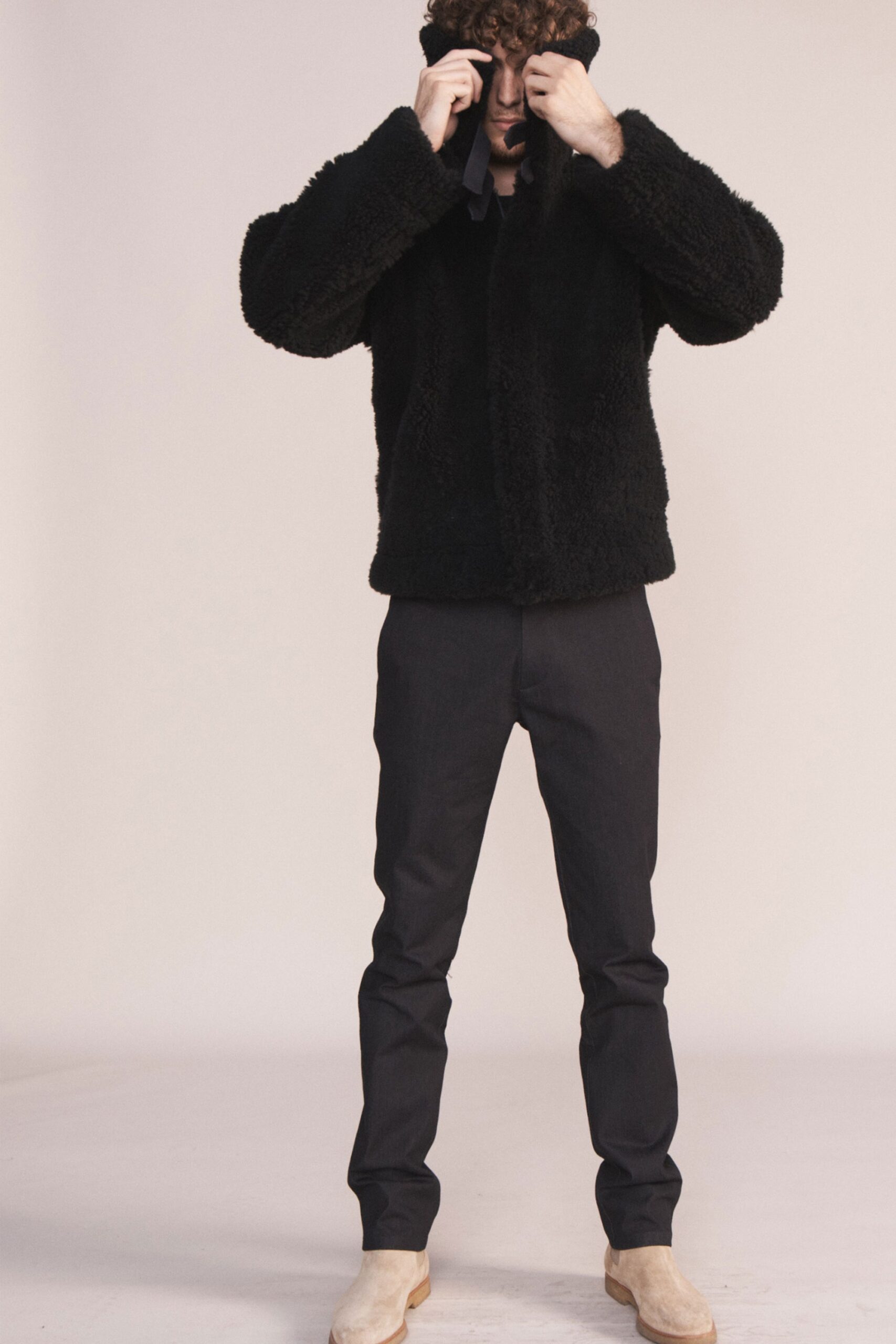 black faux-fur jacket with slim pants
