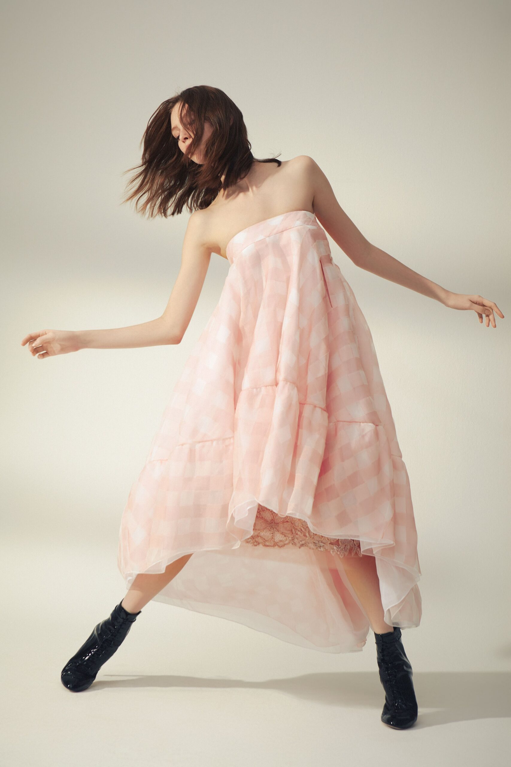 pink tiered strapless gown with black boots