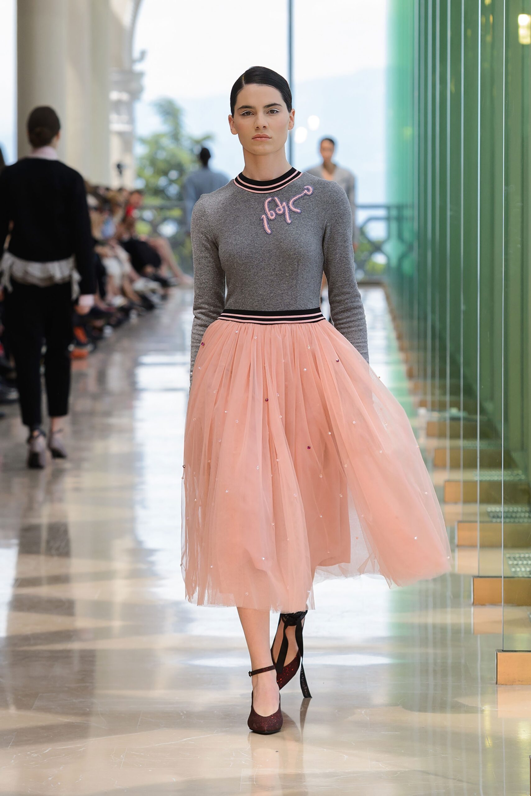 gray fitted top with pink pleated skirt
