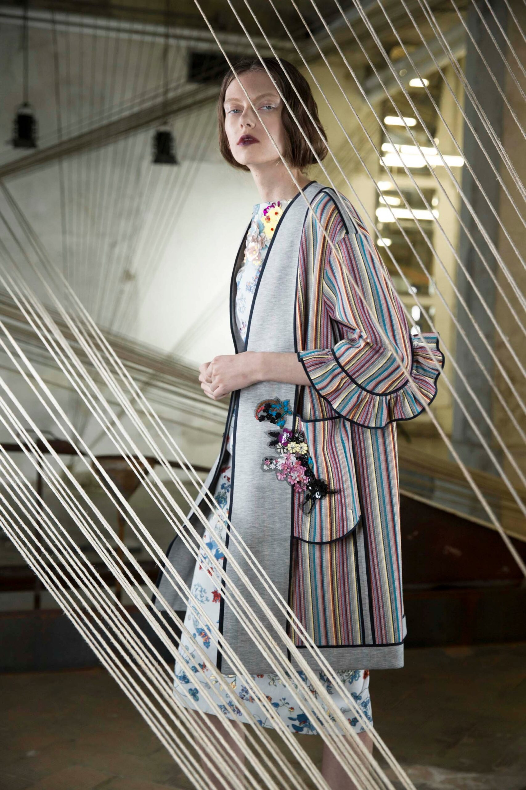gray multi-layered coat and white floral dress
