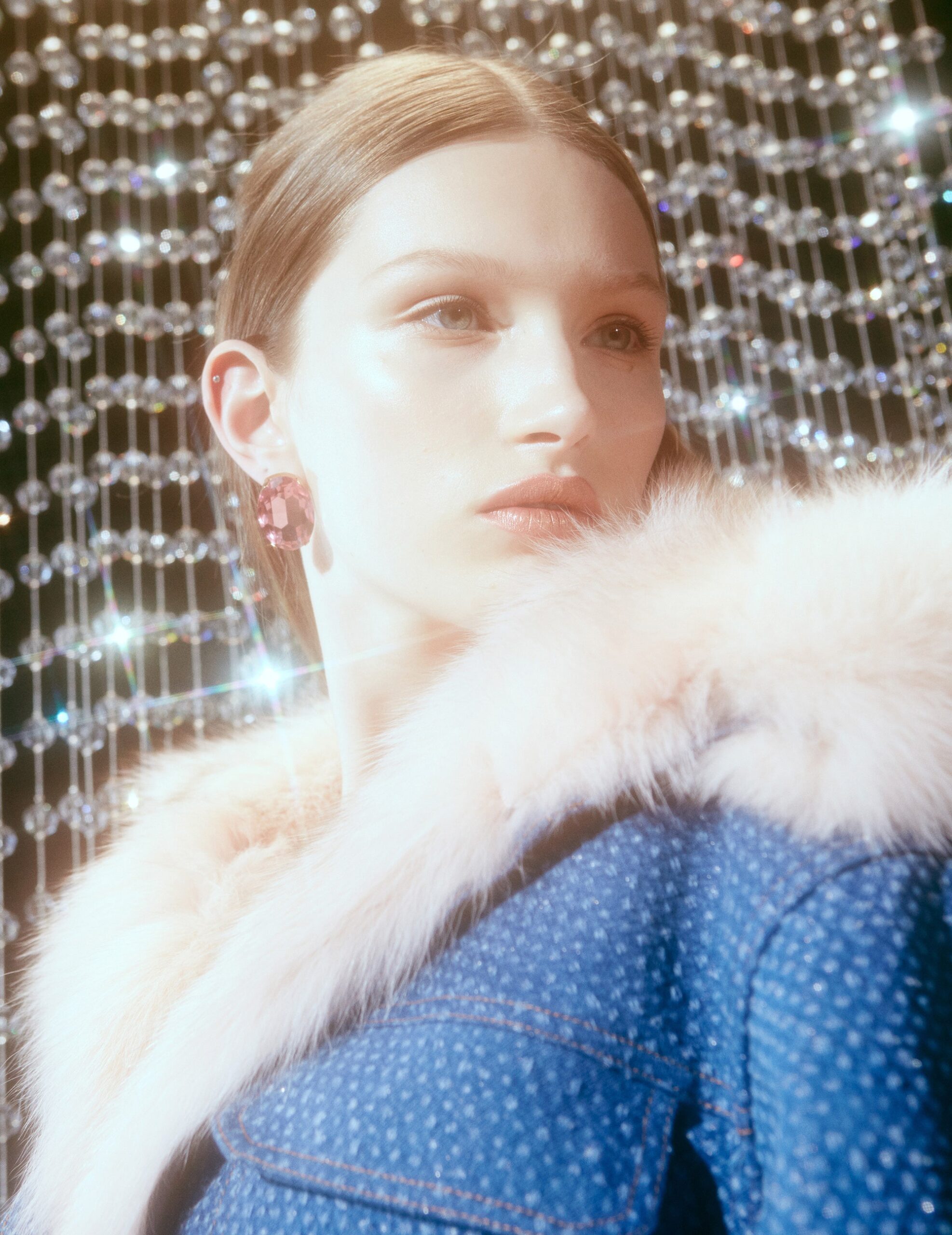 fitted blue denim jacket with pink earrings