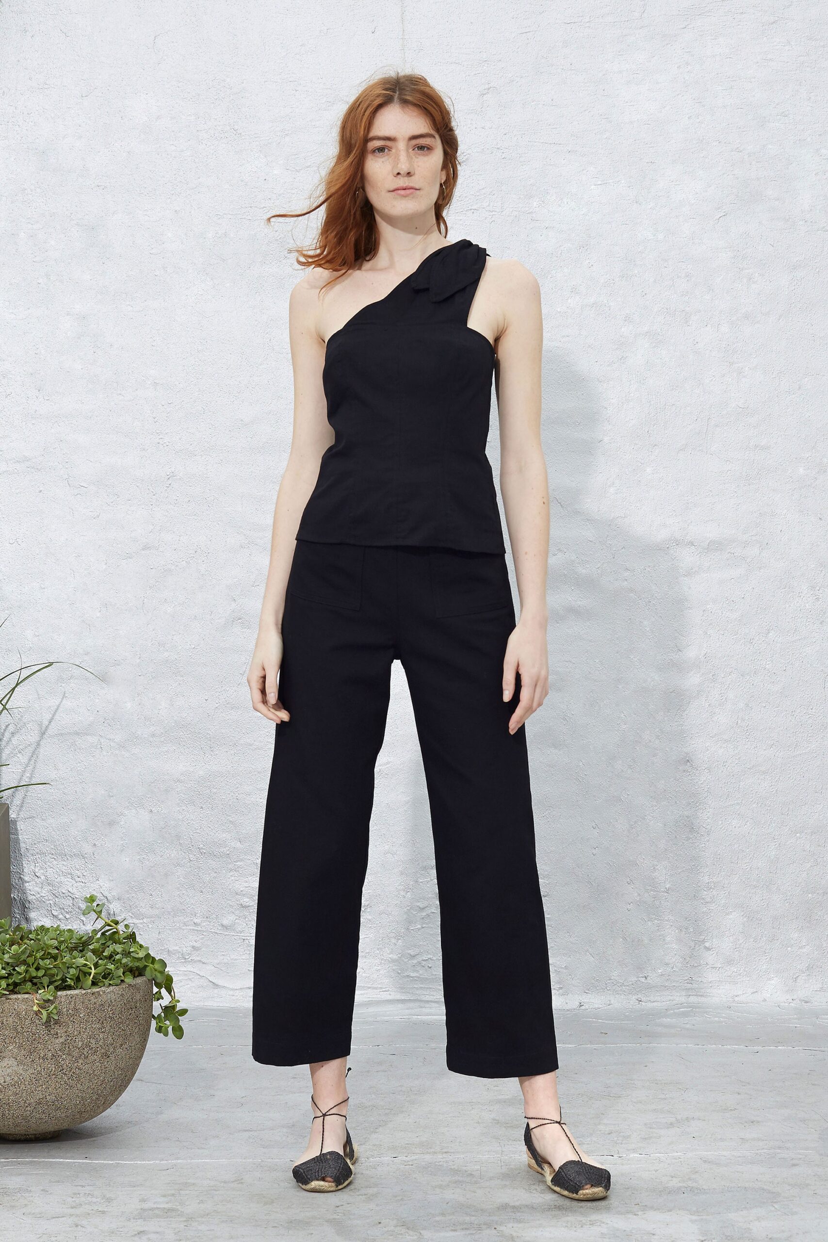 black fitted asymmetric top and relaxed pants
