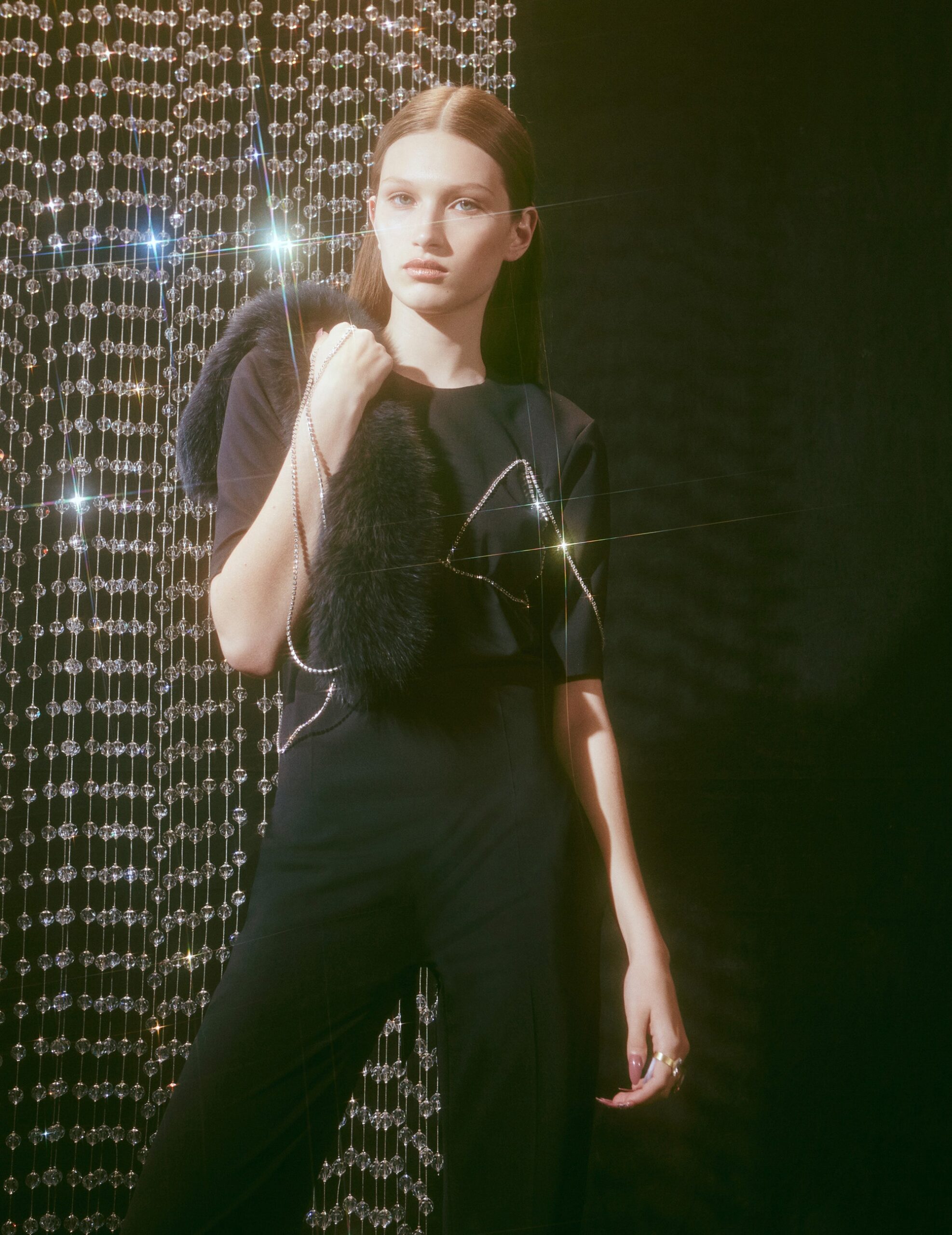 black fitted jumpsuit with fur bag