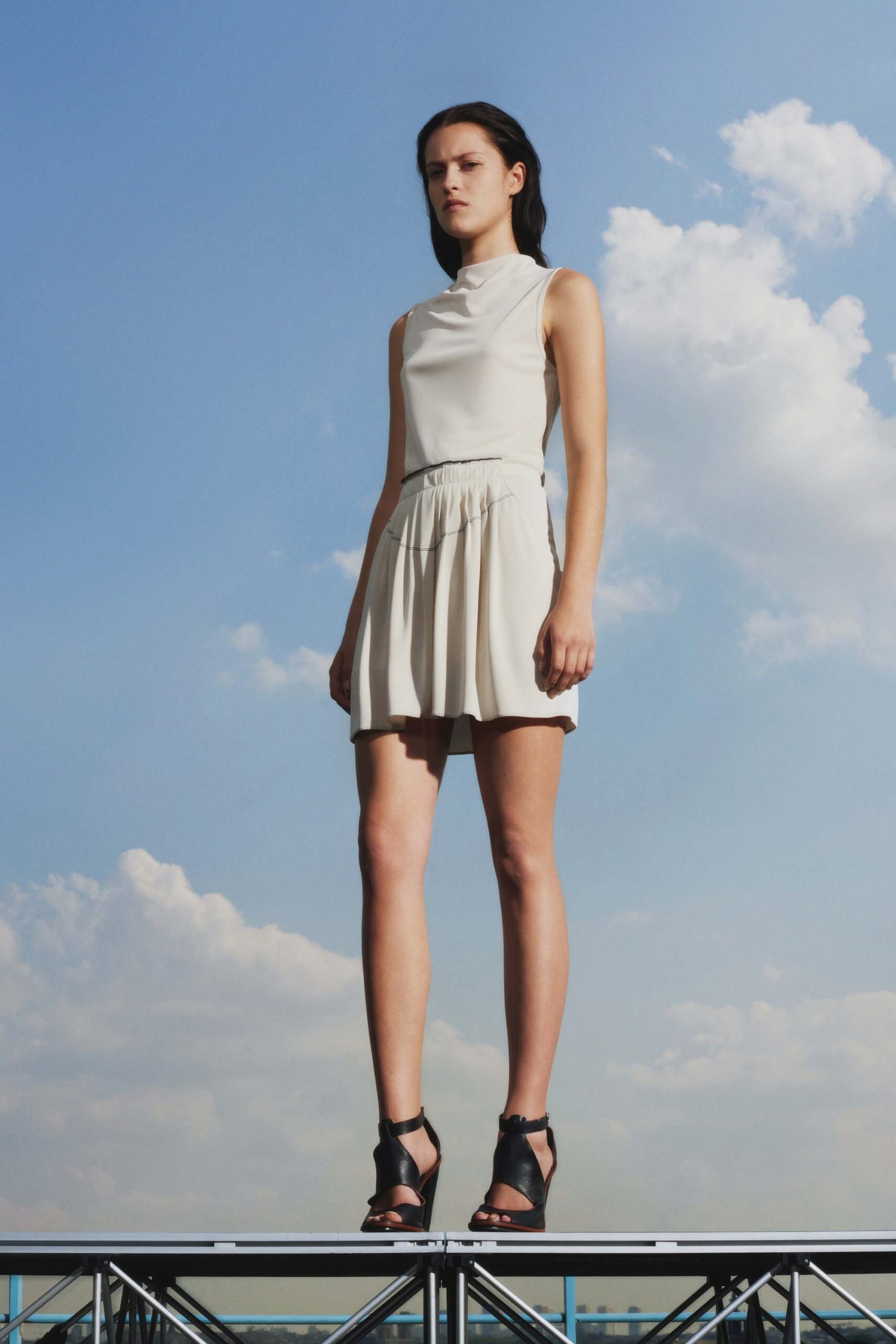 white pleated mini dress with black shoes